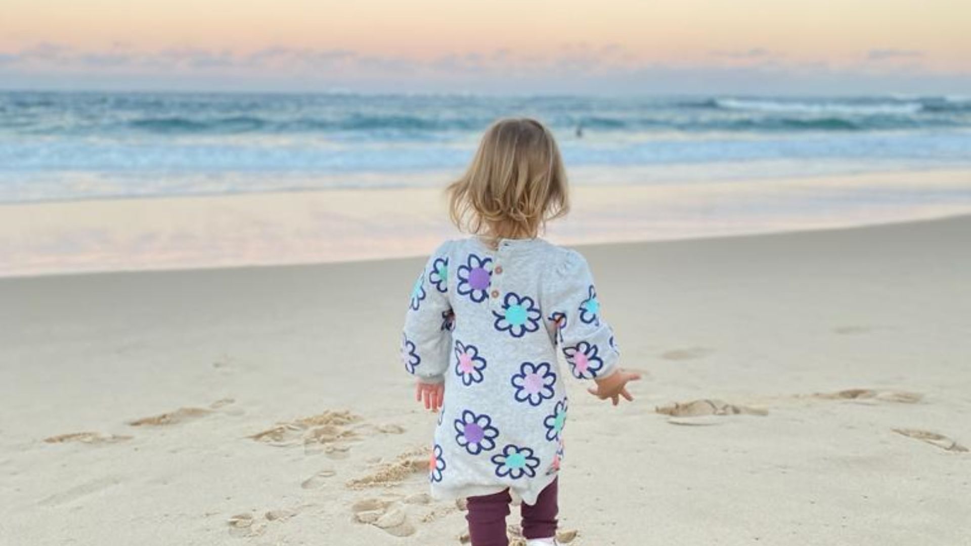 A Child Walking On A Beach